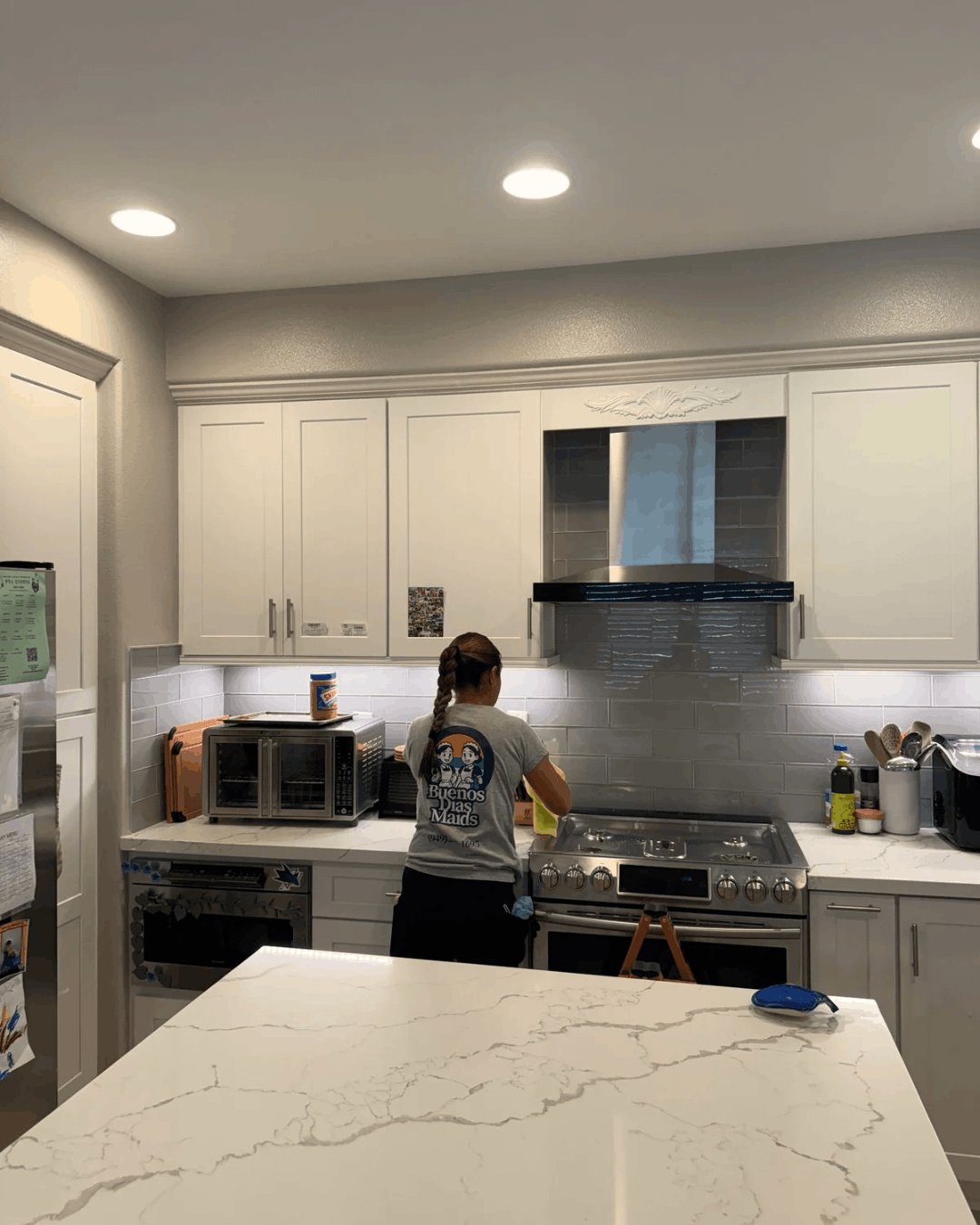 Maid cleaning stove